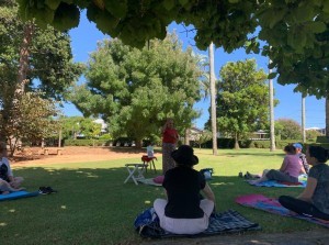 Residents meditating in the park